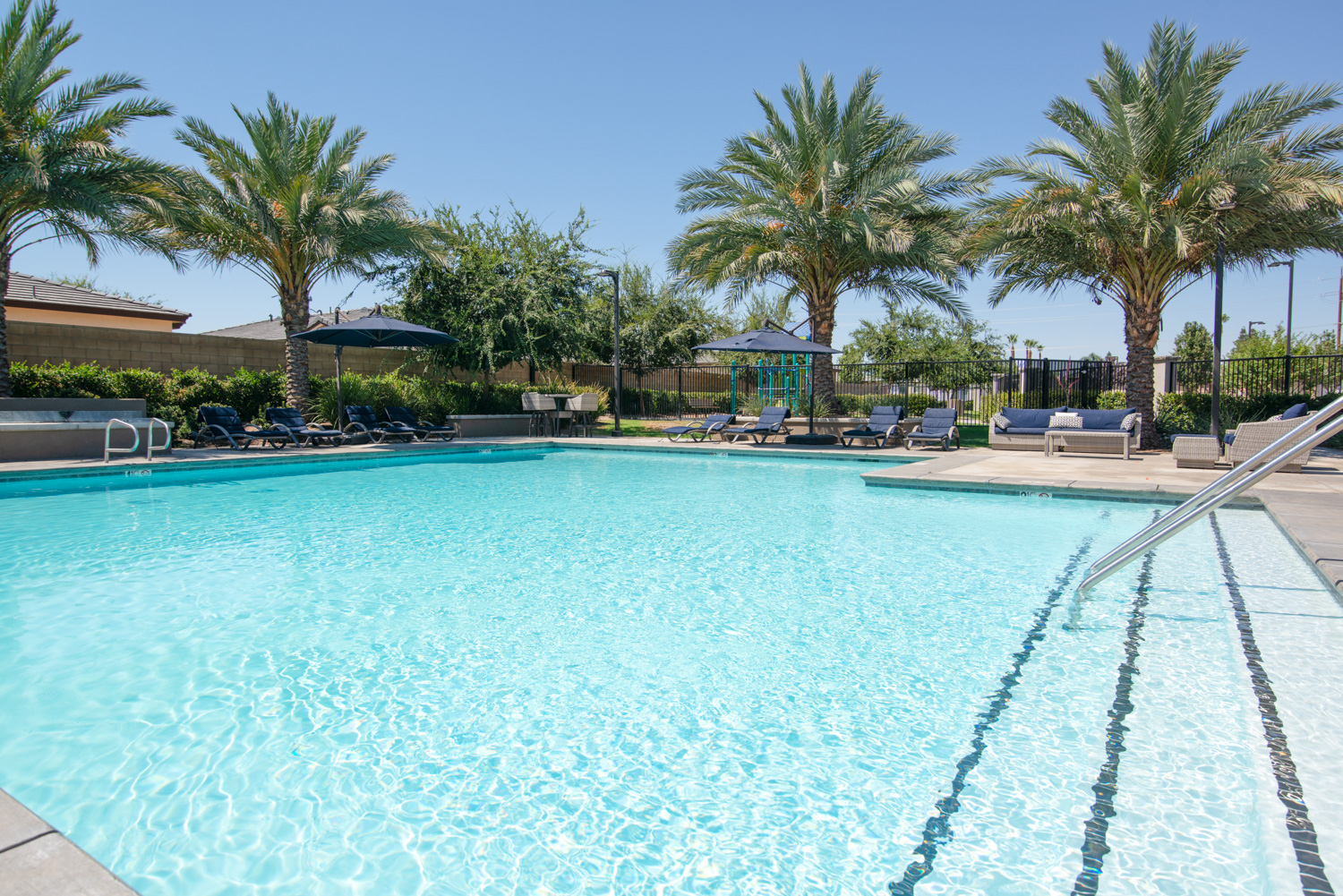 Here is a photograph of a resort-style pool captured from an impressive angle, emphasizing its grandeur and inviting atmosphere. How could be make it better?