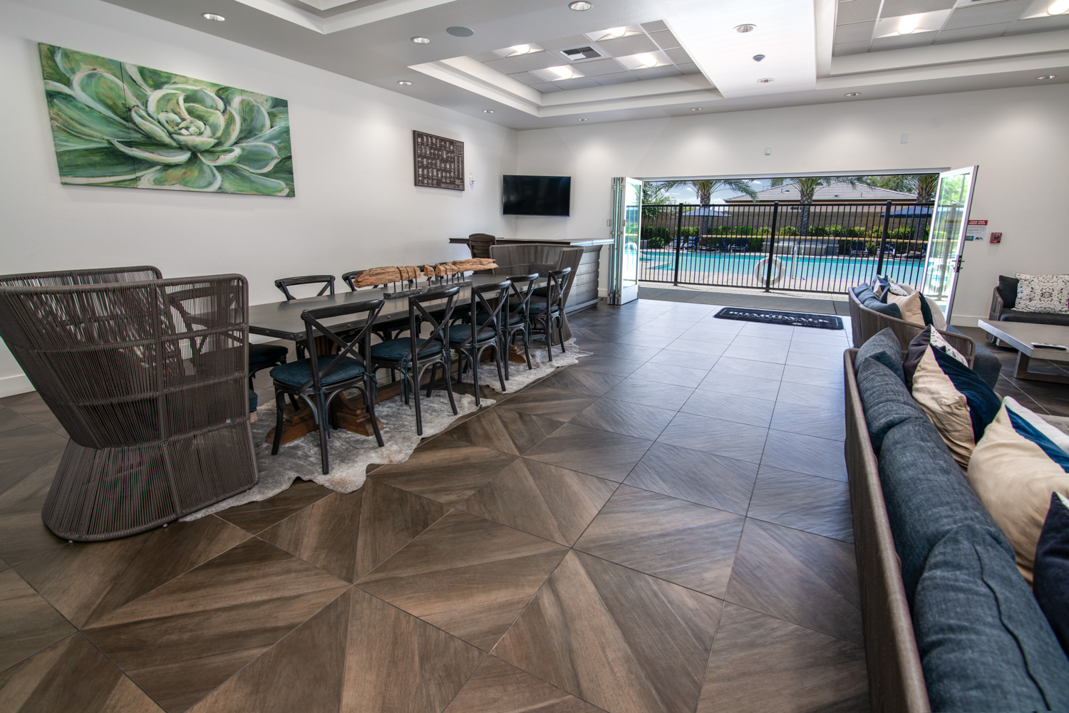 The after photograph of a high-end recreation center showcases a beautiful pool view in the background. The image is enhanced by excellent lighting, perfect details, and ultra-rich colors, presenting the space in its best light.