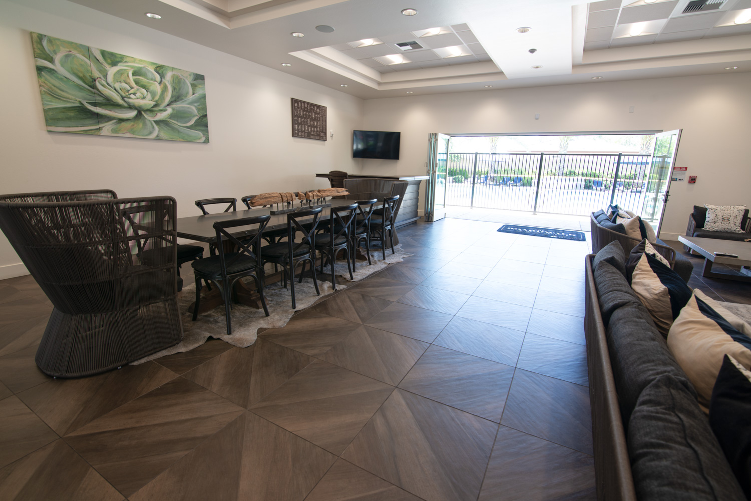 A before image of a high-end recreation center featuring a window wall. Unfortunately, the photograph fails to fully capture the view outside or showcase the interior's complete glory, typical of many such images.