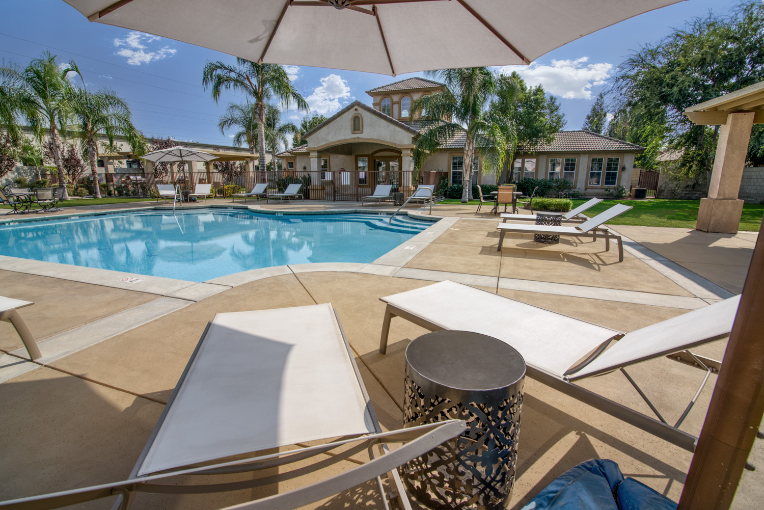 Take a look at the same image after our work. The pool is an appealing blue. The stained concrete looks spectacular. Don’t forget the sky and the rich detail that shadows were hiding.