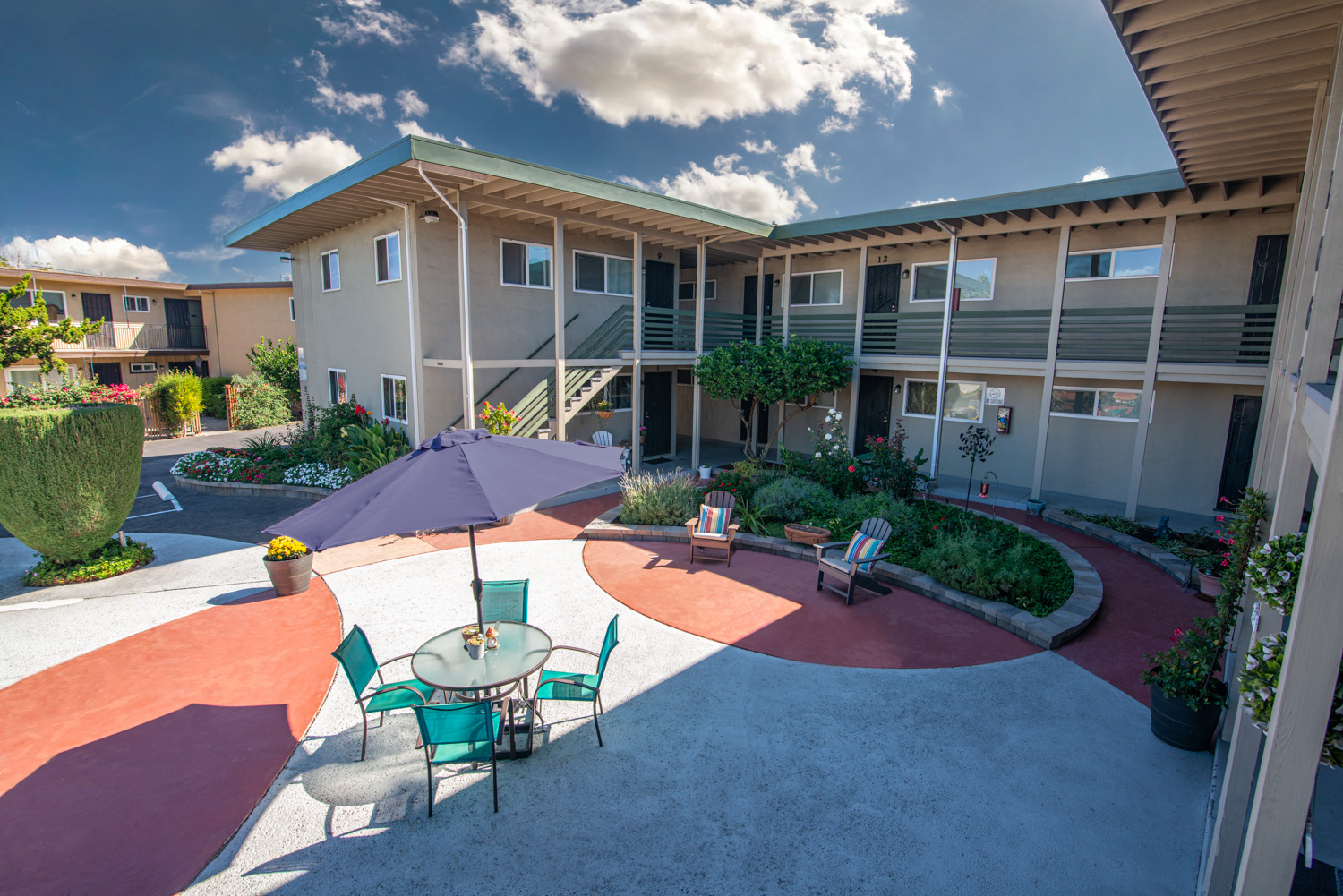 An after image of a smaller apartment's courtyard with previous flaws corrected, featuring an enhanced, amazing sky and other visual improvements, creating an impressive and appealing appearance.