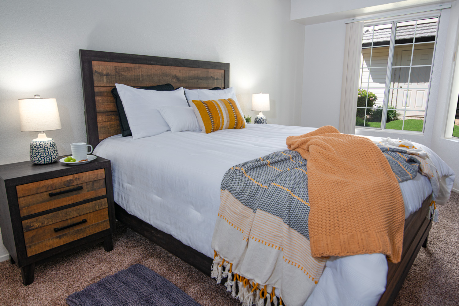 After Photoshop corrections and enhancements, the room appears bright and livable, with improved visibility of the view through the window.